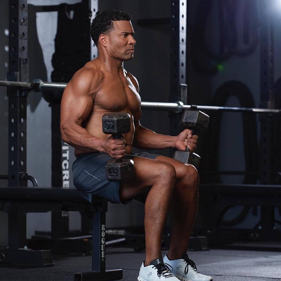 Man on bench with dumbbells.