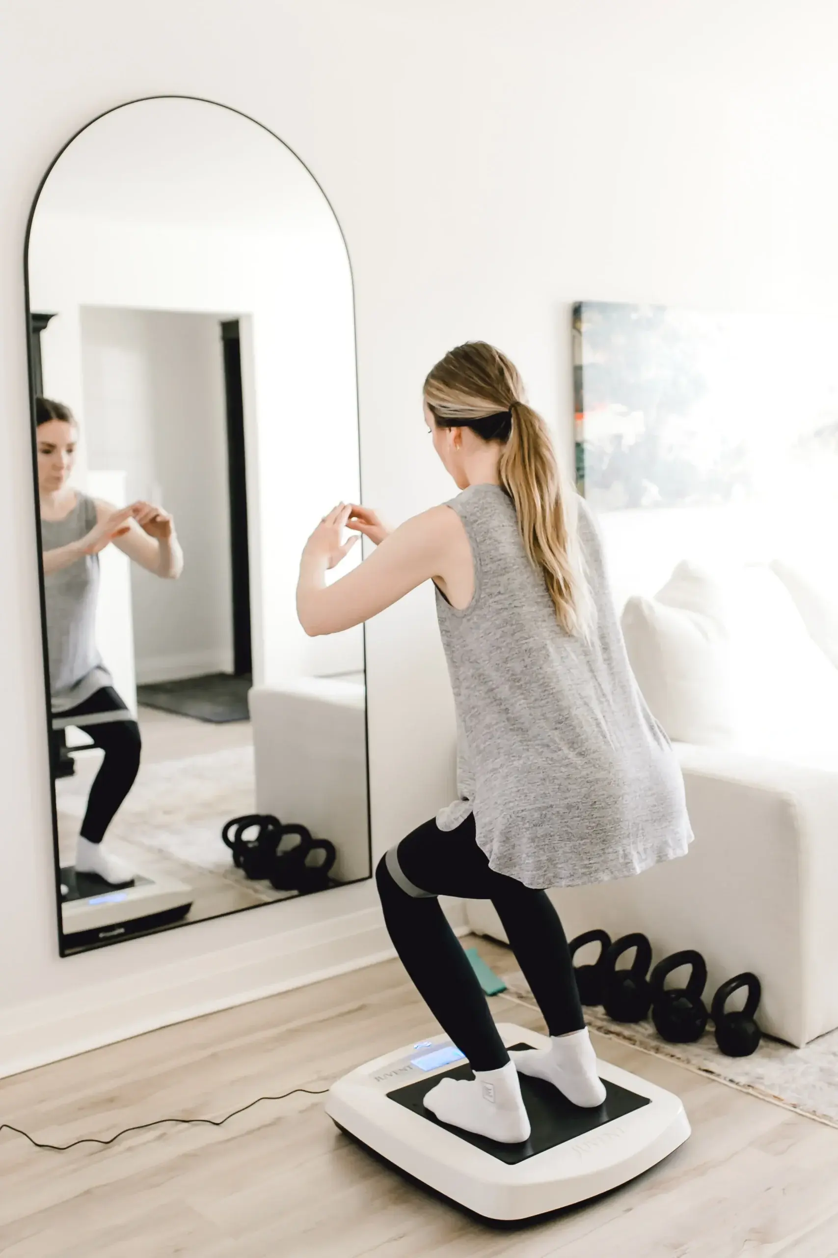 Person doing squats on a vibration plate