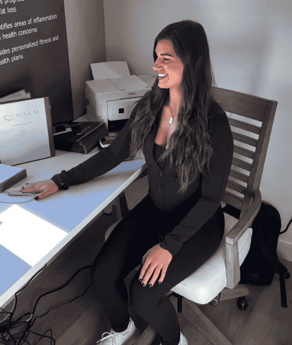 Woman in black sitting at desk with computer